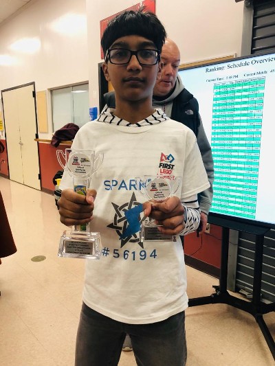 Boy Wearing Eyeglasses with Trophies